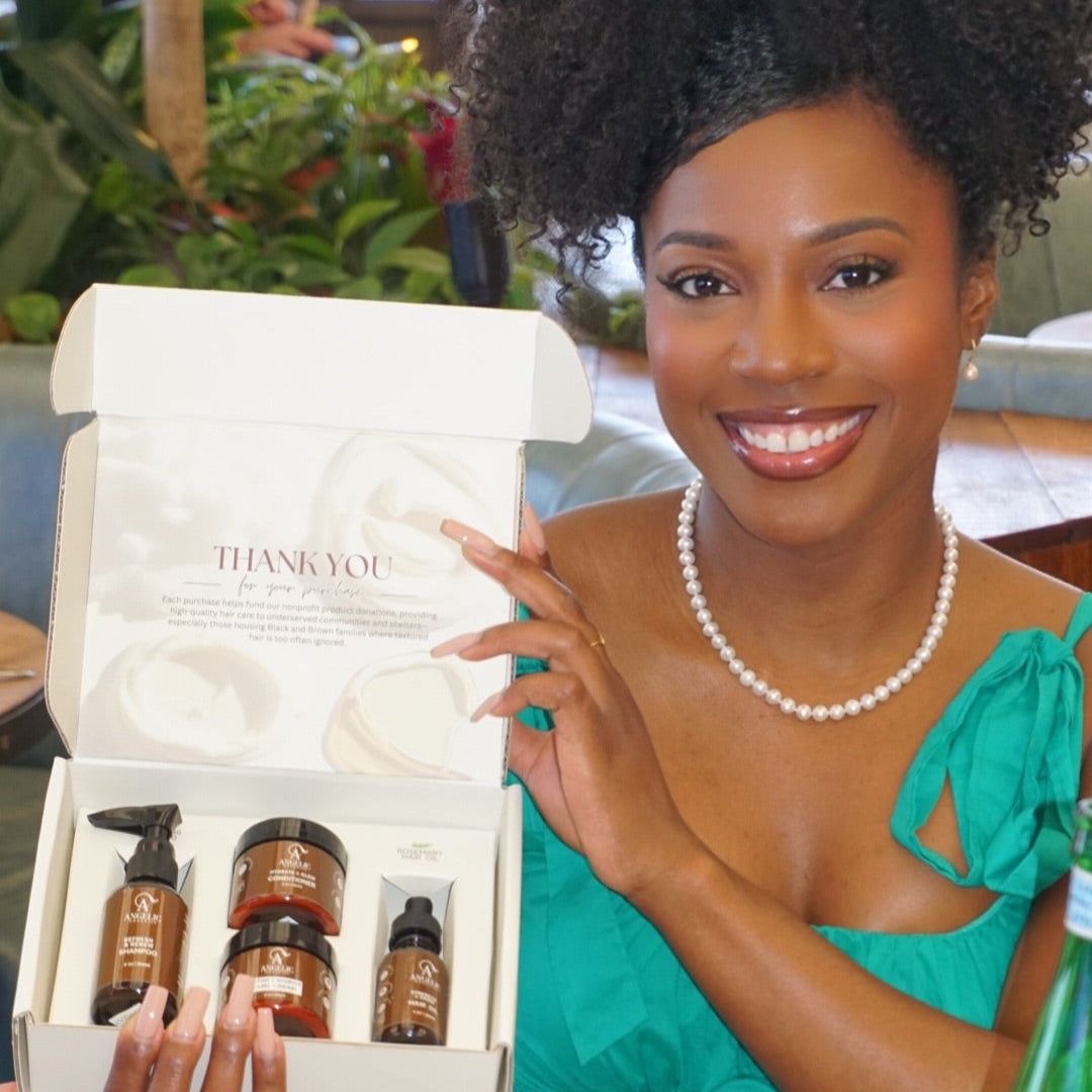 Woman holding a haircare gift set of shampoo, conditioner, hair cream, and oil product set. 